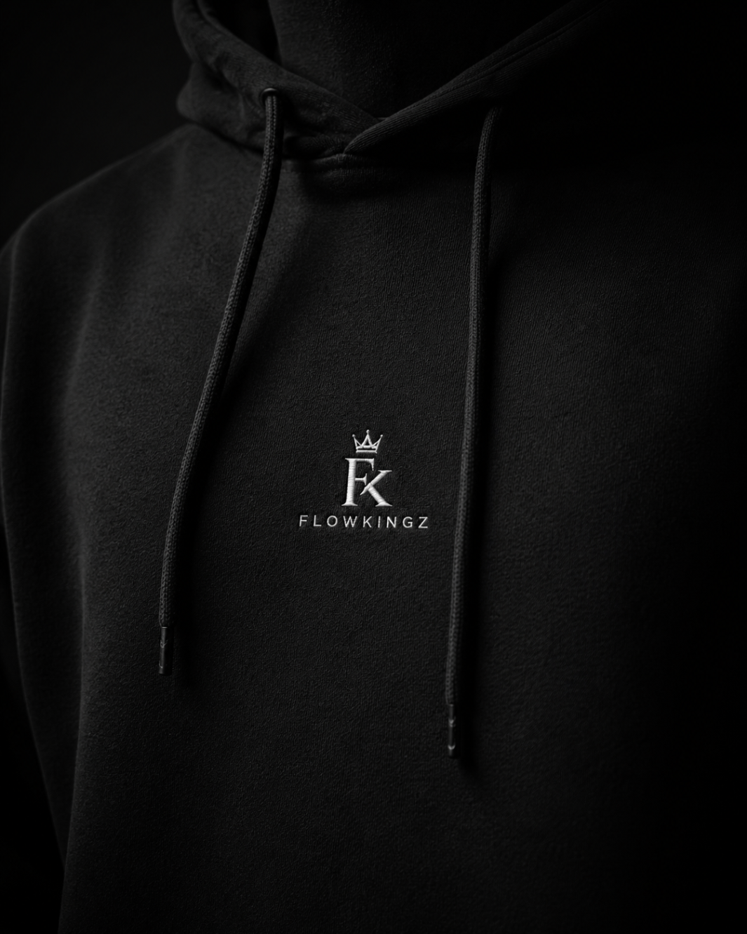 Close-up of the embroidered FlowKingz crown on black heavyweight cotton